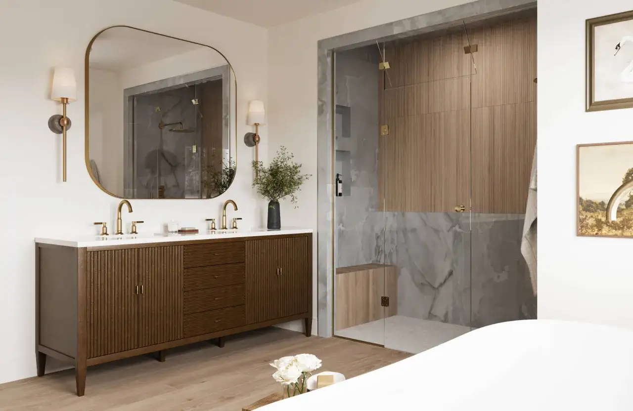 A modern bathroom features a dark wood, fluted freestanding vanity against a wall, topped with a white countertop and brass faucets.