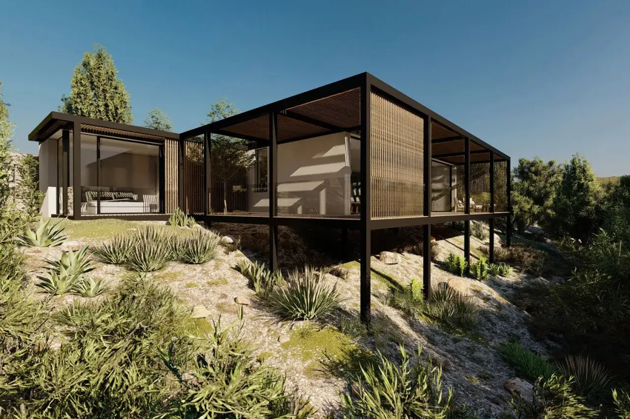 Una moderna casa prefabricada se alza sobre una colina rocosa, rodeada de vegetación.