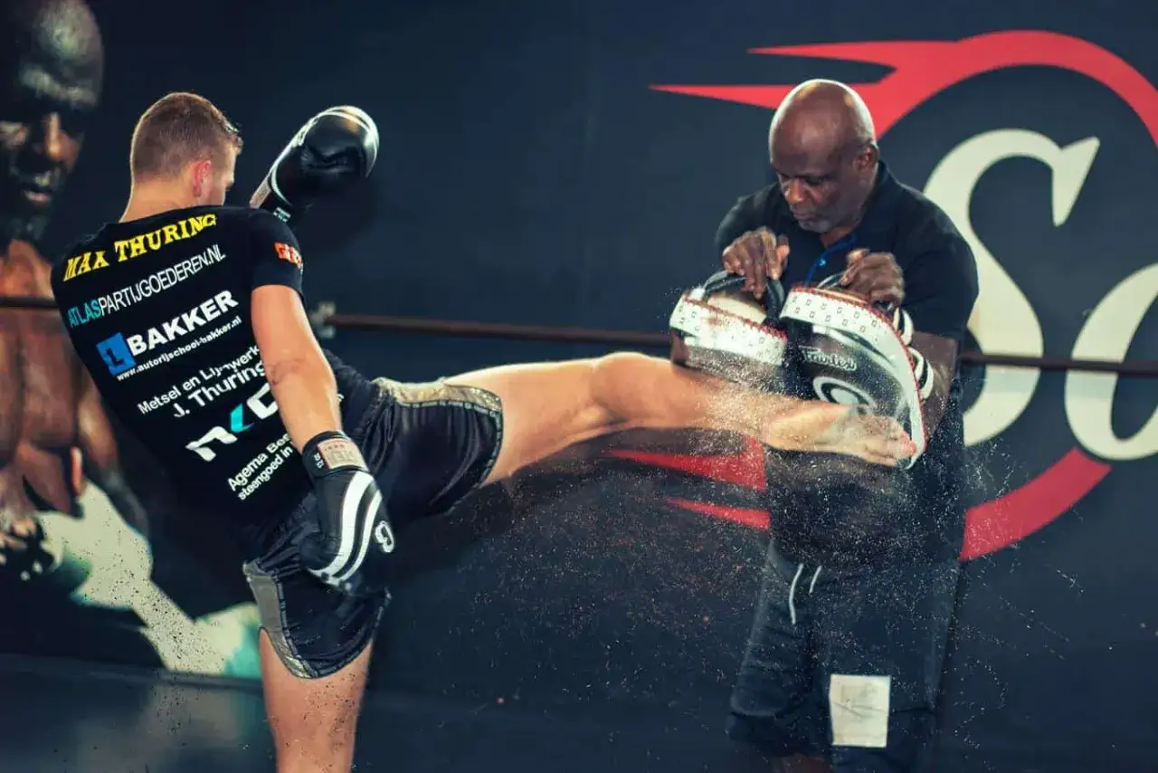 En fighter tr&auml;nar sparkar med en coach som h&aring;ller upp skydd. Kanske en framtida Ernesto Hoost i vardande.