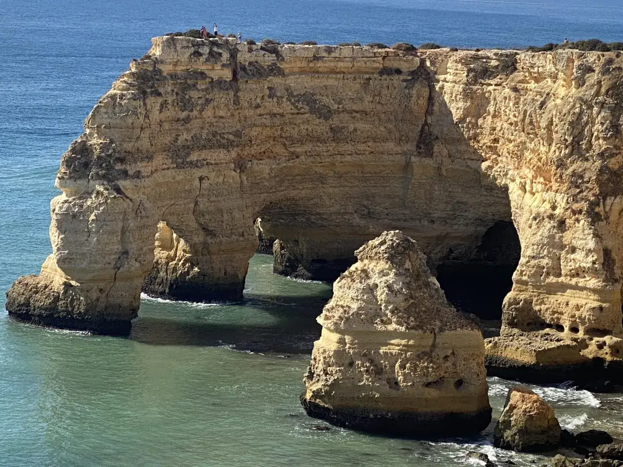 Felsformationen mit Bögen im Meer, die an die Küste von Carvoeiro Altstadt erinnern.