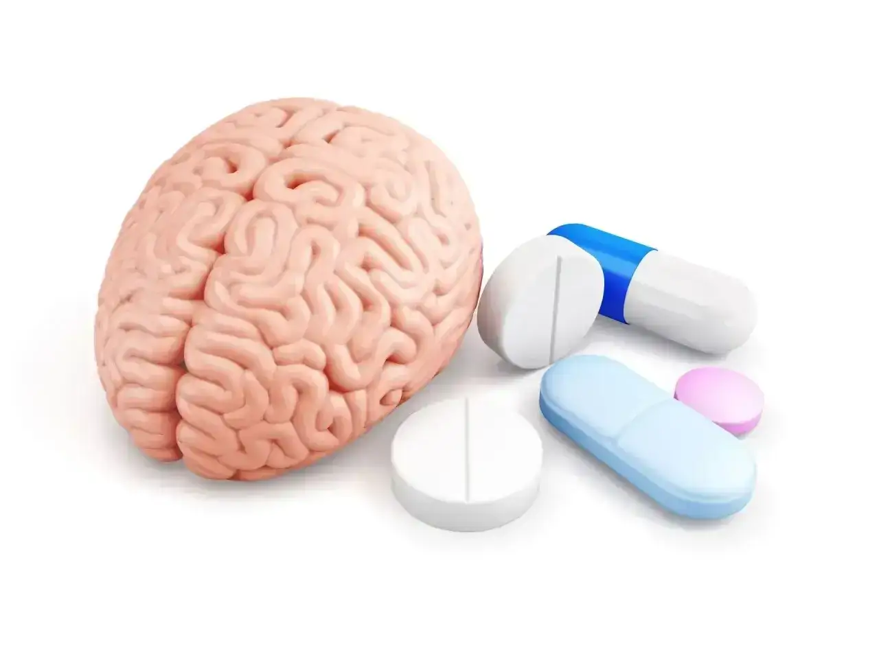 Model ludzkiego mózgu obok różnych tabletek i kapsułek, symbolizujących psychotropy.