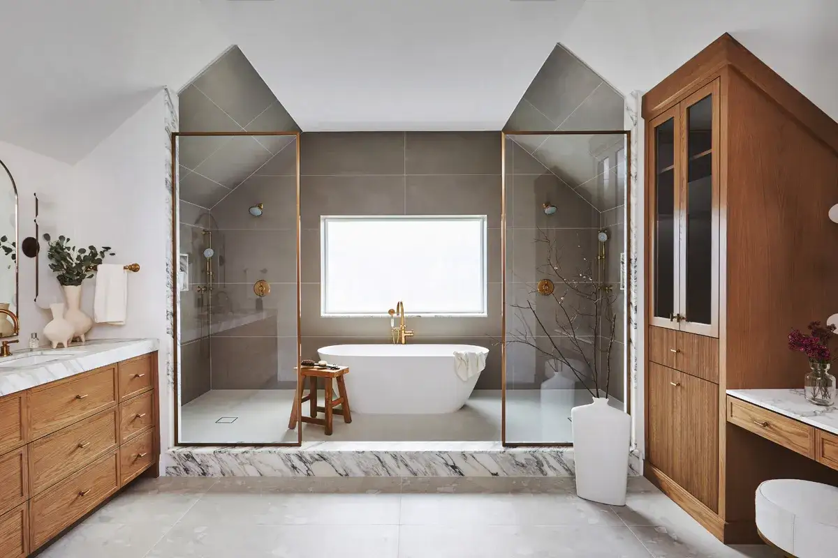 A luxurious bathroom with a freestanding tub, dual showers, and wooden vanity. This serene space makes you wonder, do hot showers make you sleepy?