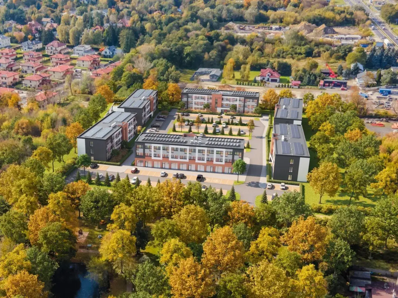 Nowe bloki mieszkalne otoczone jesiennym lasem, z parkingiem i placem zabaw. Czy to kolejna odsłona patodeweloperki?