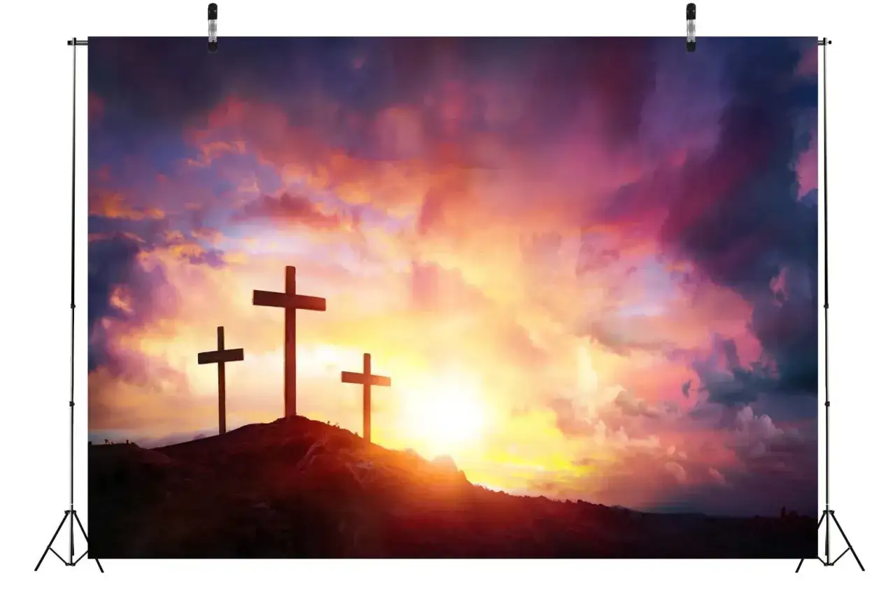 Three crosses stand silhouetted against a vibrant sunset, a testament to the sovereignty of God.