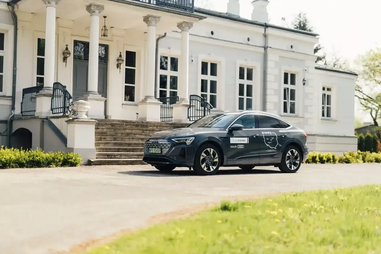 Elegancki Audi e-tron przed zabytkową willą. To idealna ulga na samochód dla koneserów stylu i komfortu.