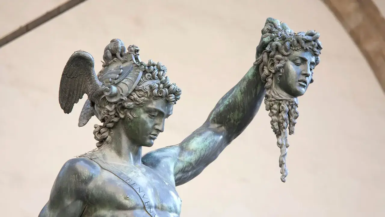 Perseusz z odciętą głową Meduzy, kt&oacute;rej włosy zastąpiły węże. Bogini z wężami na głowie pokonana.