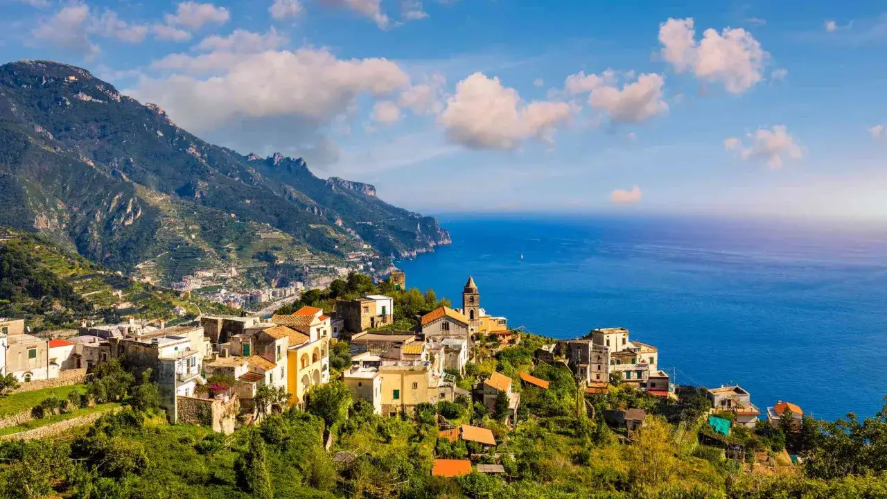 Scenic view of Ravello, Italy, perched on a cliff overlooking the sea. Planning how to get from Naples to Ravello? This picturesque town is a rewarding destination.