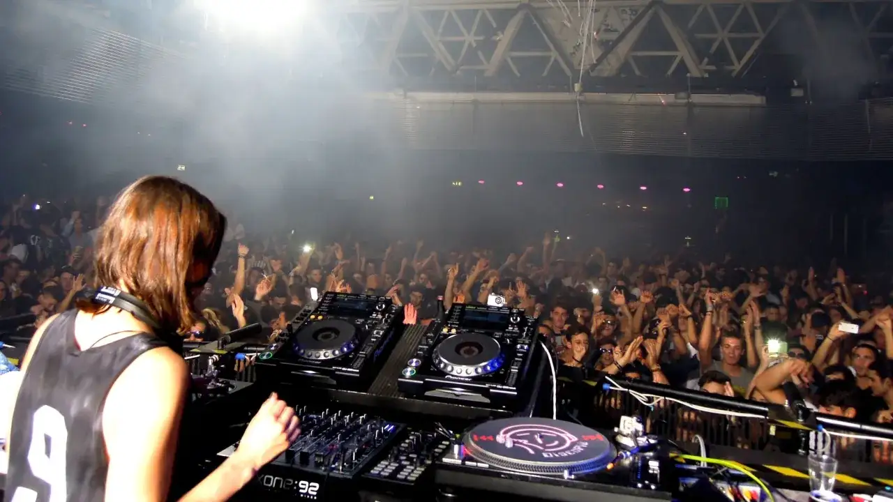 Dj kobieta w akcji, tłum szaleje na koncercie.