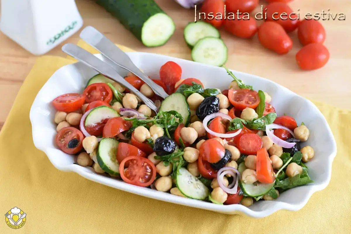 Insalata di ceci estiva con pomodorini, cetrioli, olive nere e cipolla rossa. Fresca e colorata, perfetta per l'estate.