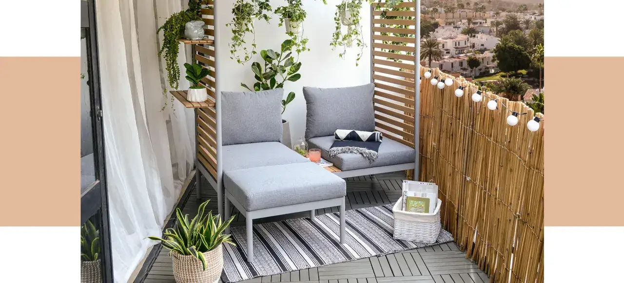 Mysig liten balkong inspiration med gr&aring; soffa, v&auml;xter och ljusslinga. Perfekt f&ouml;r avkoppling.