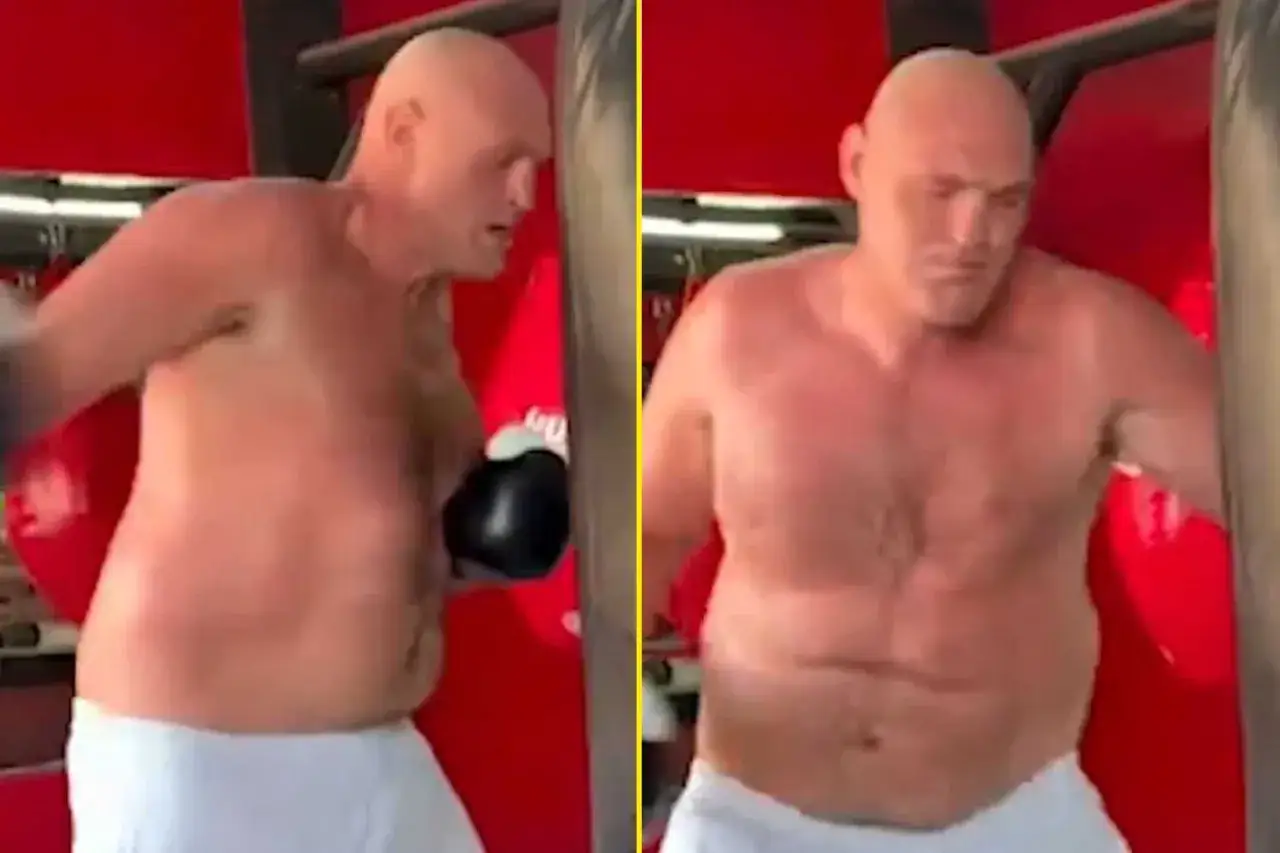 Tyson Fury's powerful build is on display as he trains, his muscular physique evident during a boxing workout.