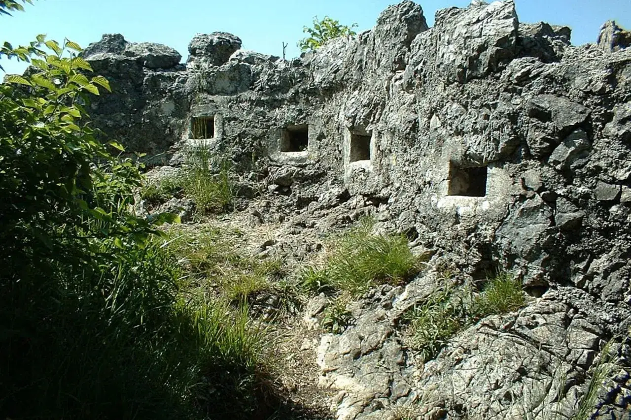 Antiche feritoie nel **forte di Orino**, incastonate nella roccia, testimoniano storie di difesa e vigilanza.