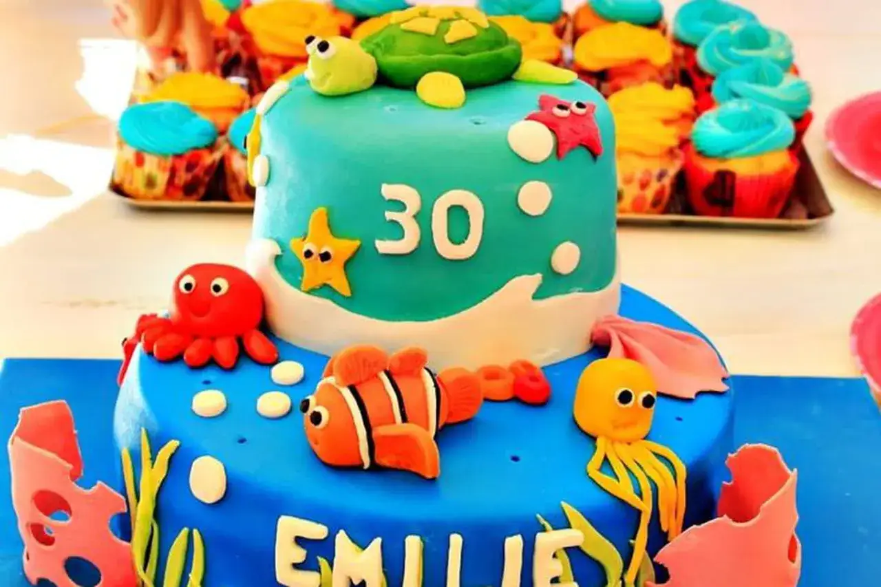 Gâteau d'anniversaire 30 ans thème marin, avec une tortue, des poissons, des étoiles de mer et des poulpes en pâte à sucre. Une recette gâteau pâte à sucre facile pour une fête inoubliable.