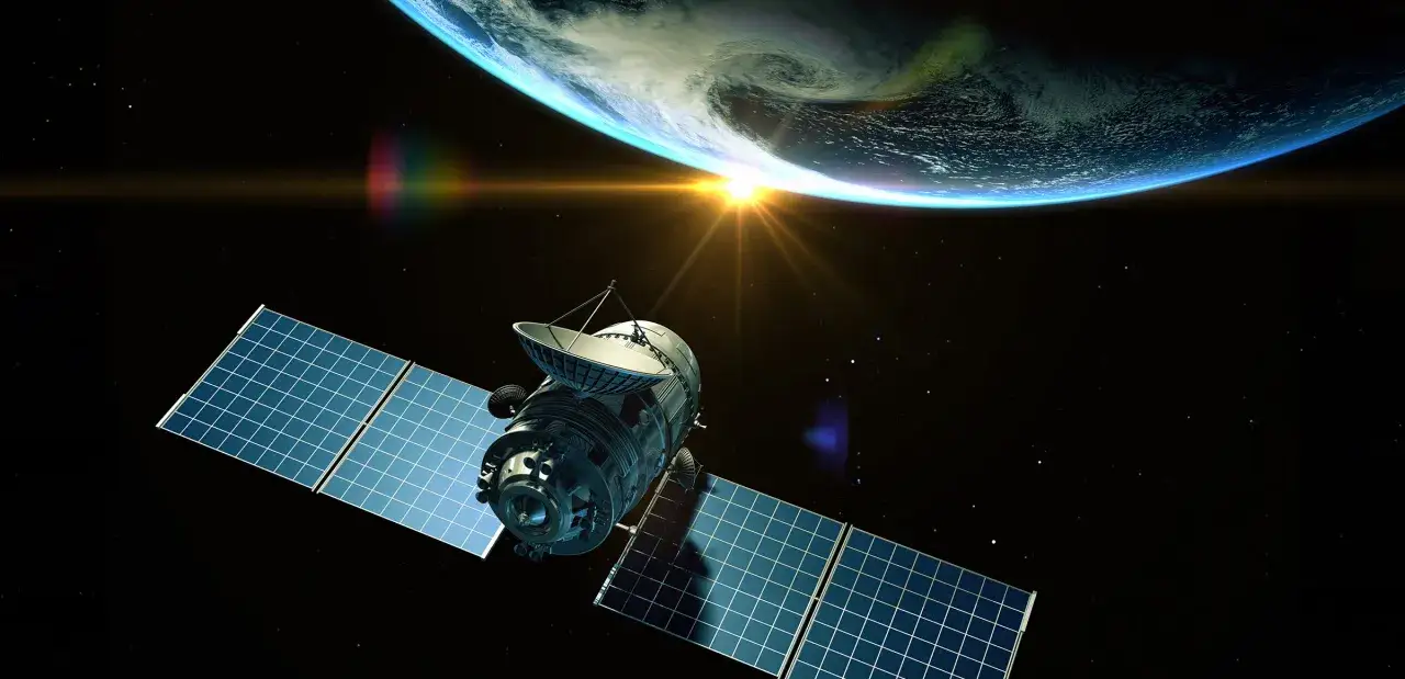 Satelita z panelami słonecznymi i anteną paraboliczną na tle Ziemi i Słońca. Tak wygląda satelita w kosmosie.