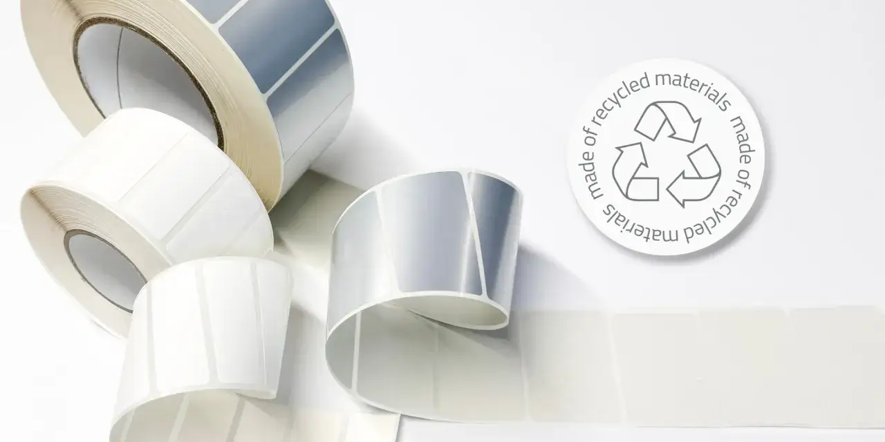 Rolki etykiet, białe i srebrne, z symbolem recyklingu. Co jeśli serial o zrównoważonym druku?