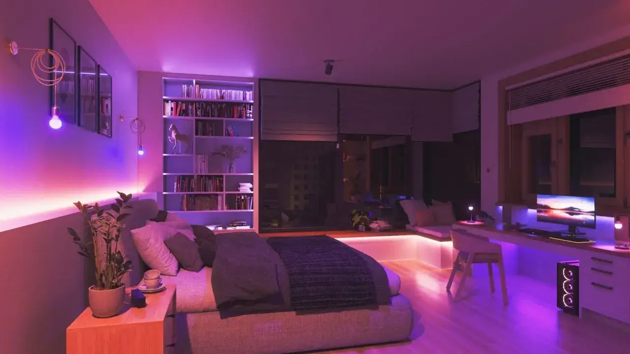 A bedroom with a bed, bookshelf, and desk, all bathed in vibrant rgb light ideas. The purple and pink hues create a modern, cozy atmosphere.