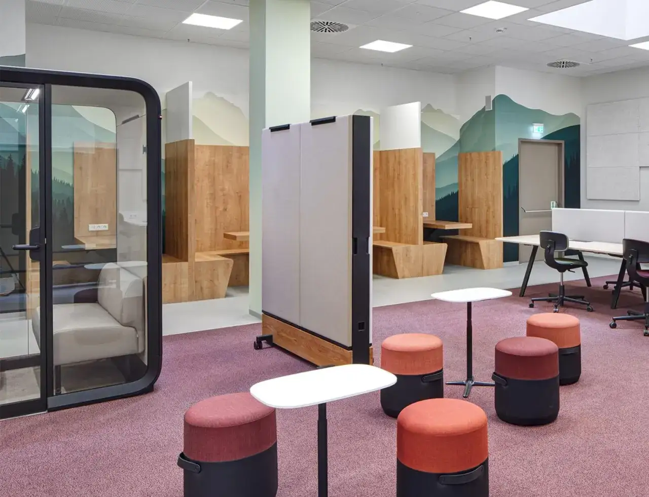 Modern homeschool room ideas: a versatile space with private pods, wooden study nooks, and flexible seating, all set against a mountain mural.