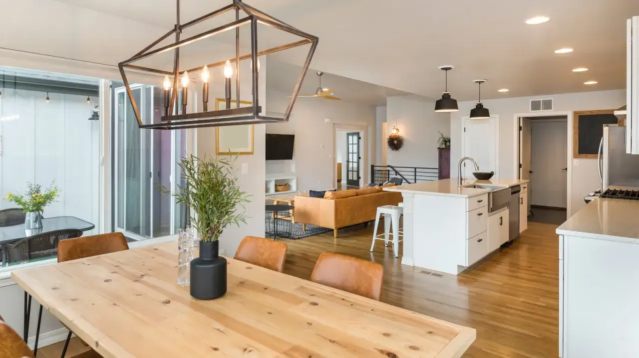 A modern farmhouse open-concept living space with a dining table, kitchen island, and living room.