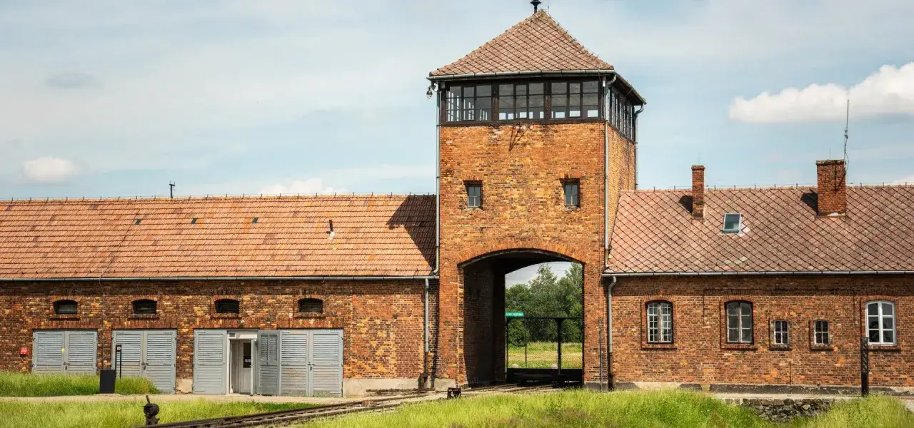 Brama obozu Auschwitz-Birkenau. Miejsce pamięci, które budzi refleksje, jak pokazują opinie o Państwowym Muzeum Auschwitz-Birkenau w Oświęcimiu.