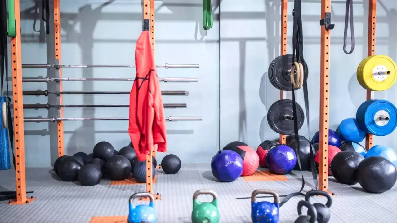 Gym equipment, including medicine balls and kettlebells, ready for a tough workout. These weights for boxing are perfect for building power.