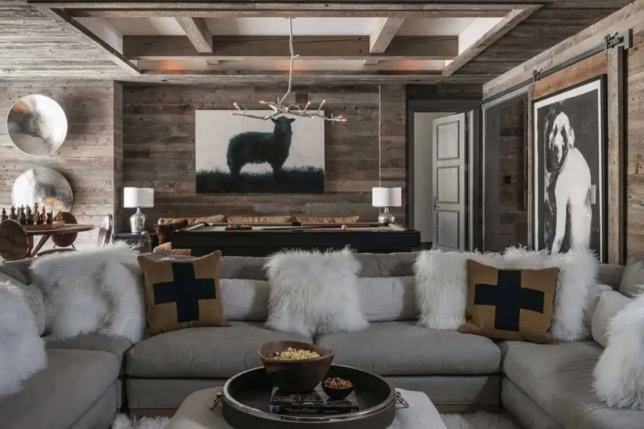 Gem&uuml;tliche luxus chalet inneneinrichtung mit Kamin, Billardtisch und Kunstwerk eines Schafes.