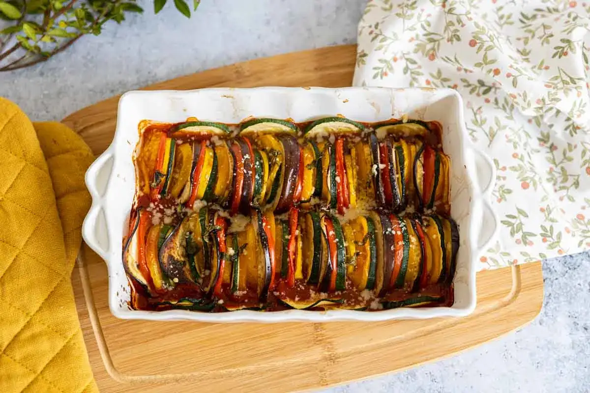 Un plat de ratatouille en tranches fines, une recette courgette tomate parfaite pour l'été, gratinée au four.