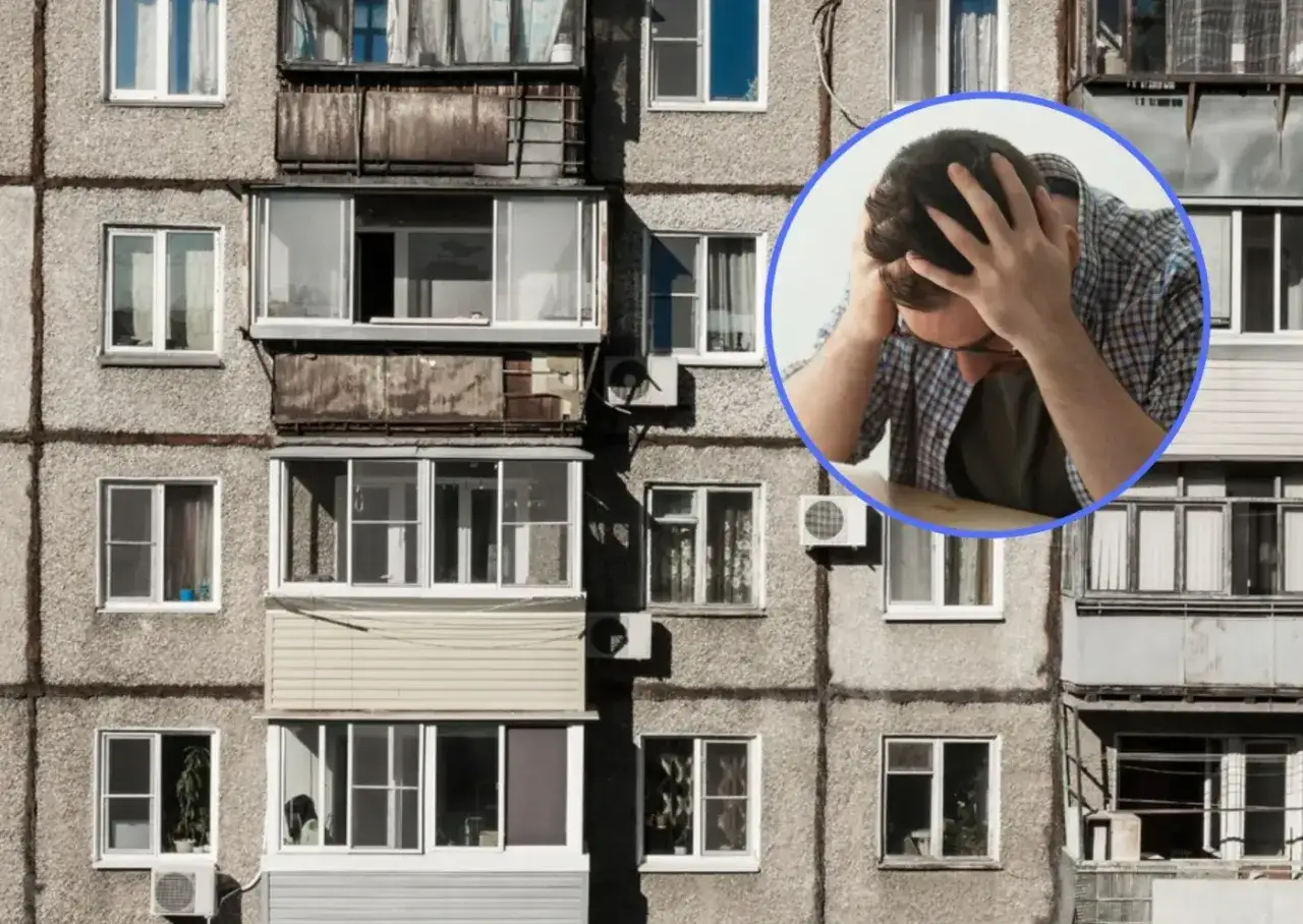 Zmartwiony mężczyzna w okręgu na tle bloku mieszkalnego. Czy komornik może wejść do wynajmowanego mieszkania?
