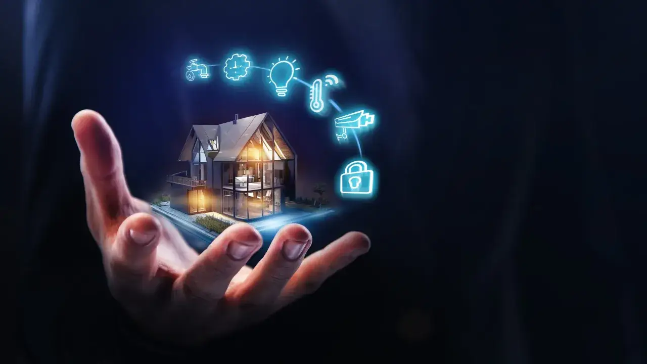 A hand holds a miniature smart home, with glowing icons representing cool IoT devices like a faucet, gear, lightbulb, thermometer, camera, and lock.