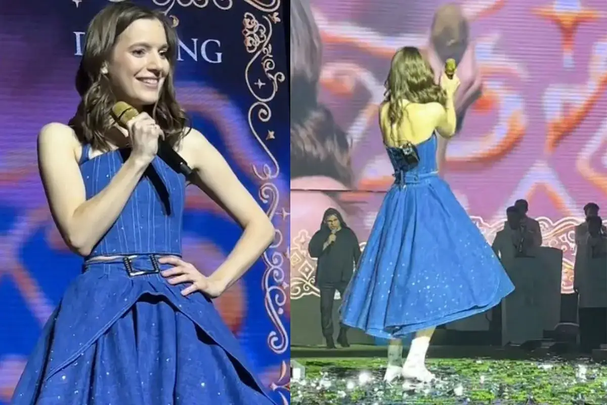 Sanah w niebieskiej sukience z błyszczącymi detalami, z mikrofonem w dłoni. Jej **wzrost** pozwala jej błyszczeć na scenie.