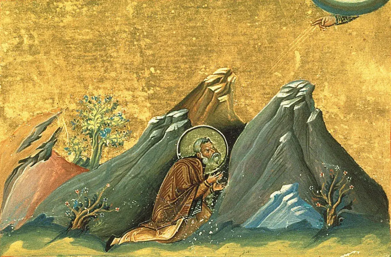 A saintly figure kneels in a rocky desert landscape, a halo around his head. This scene evokes the solitary lives of the desert fathers.