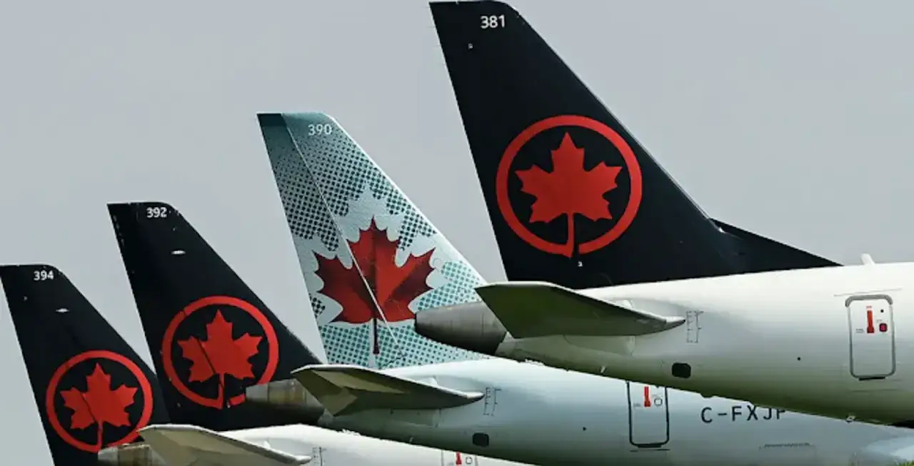 Samoloty Air Canada czekają na start. Zastanawiasz się, ile trwa lot do Kanady z Polski? To długa podróż, ale warto!