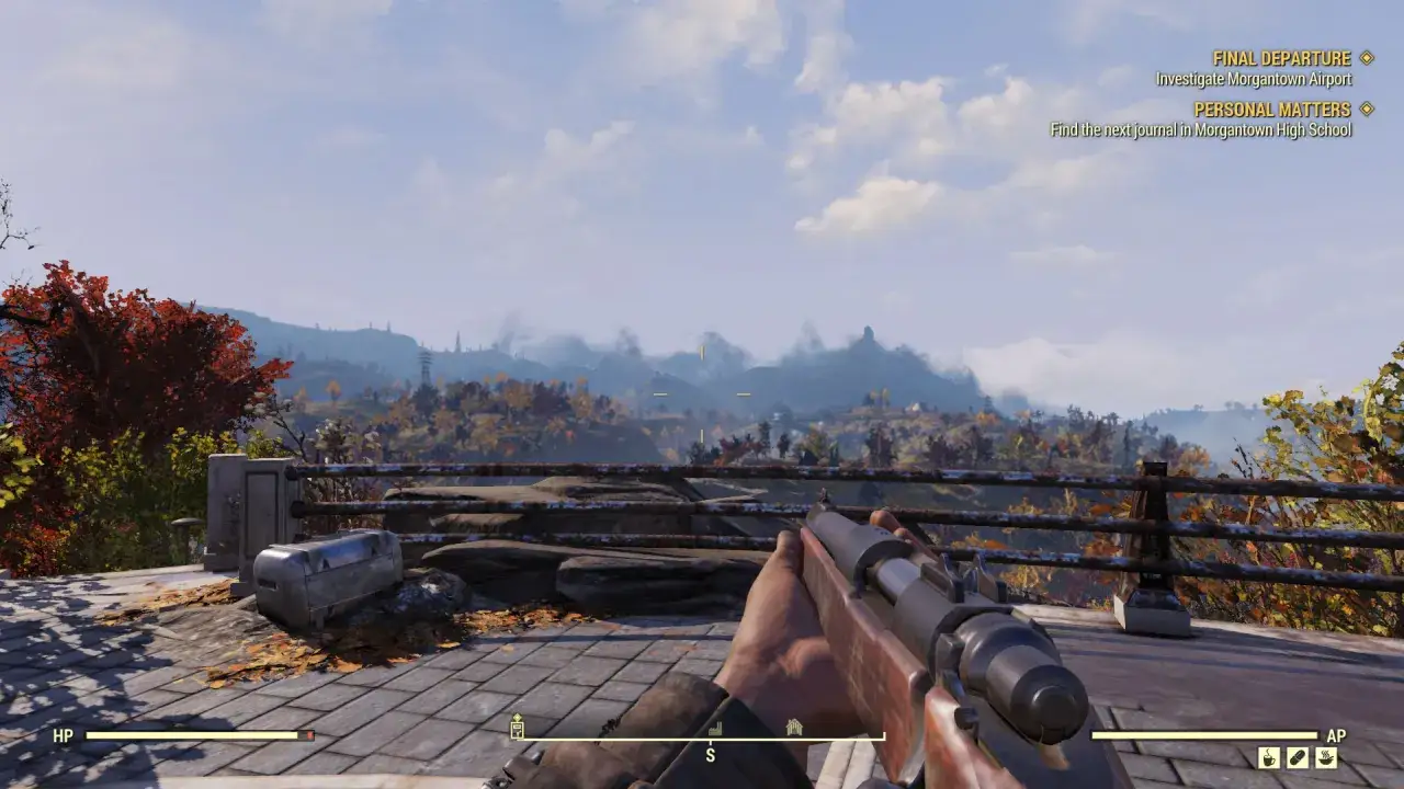 Widok z gry Fallout 76, z karabinem w ręku i celownikiem na tle jesiennego krajobrazu. Sprawdzam wymagania sprzętowe, by móc odkryć Morgantown.