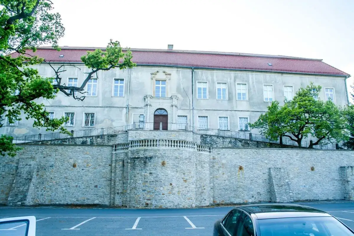 Zamek w Krapkowicach, jedna z gł&oacute;wnych atrakcji, z kamiennym murem i okazałym budynkiem.