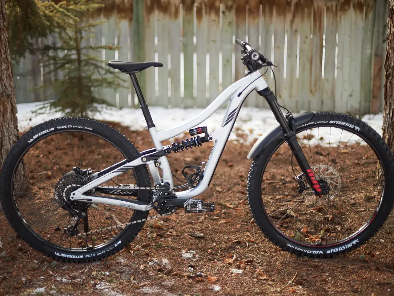 A white full-suspension mountain bike with Michelin Wild Enduro tires. The MRP logo is visible on the fork, hinting at an MRP Hazzard review.