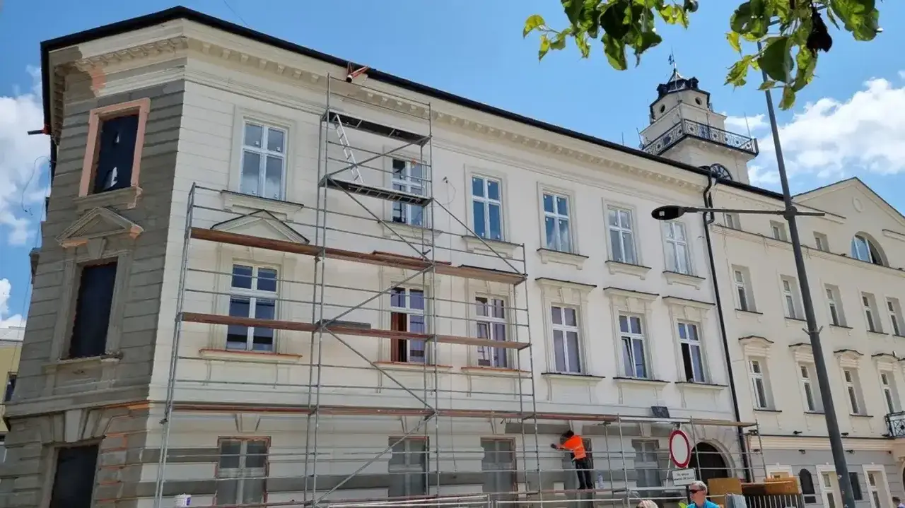 Renowacja kamienicy w Gorlicach. Widać rusztowania i pracownika. W tle wieża ratusza, jedna z gorlickich atrakcji.