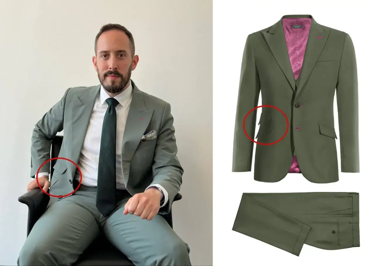 A man in a green suit with a ticket pocket, white shirt, and dark tie. The suit jacket has a bright pink lining.