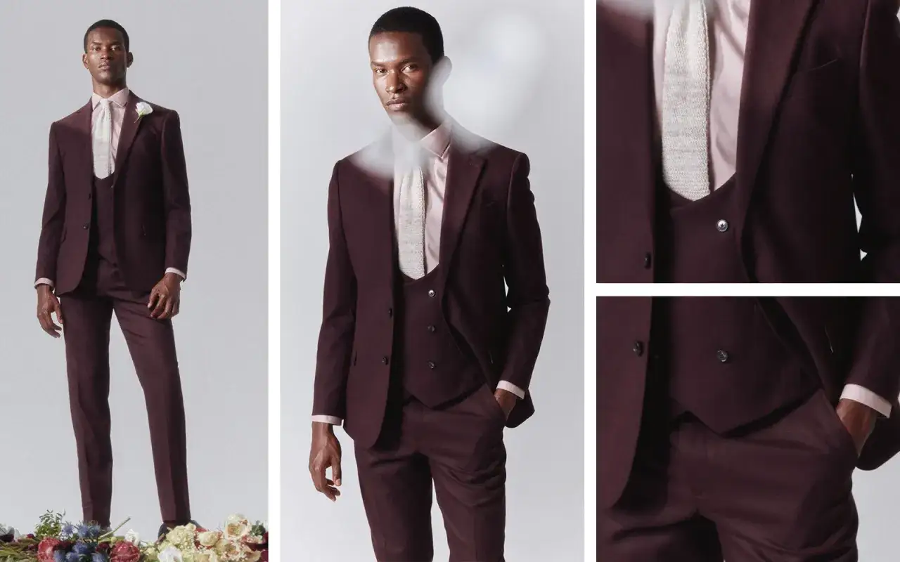 A man models a stylish burgundy suit, perfect for winter wedding attire. The ensemble includes a vest, pink shirt, and textured tie, with a boutonni&egrave;re adding a classic touch.