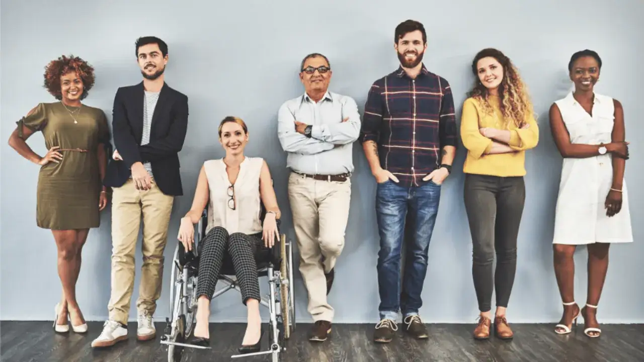 A diverse group of people, including a woman in a wheelchair, showcase diversity equity and inclusion best practices.
