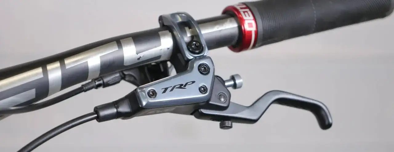 Close-up of a TRP brake lever on a bicycle handlebar, ready for a trp brakes review.