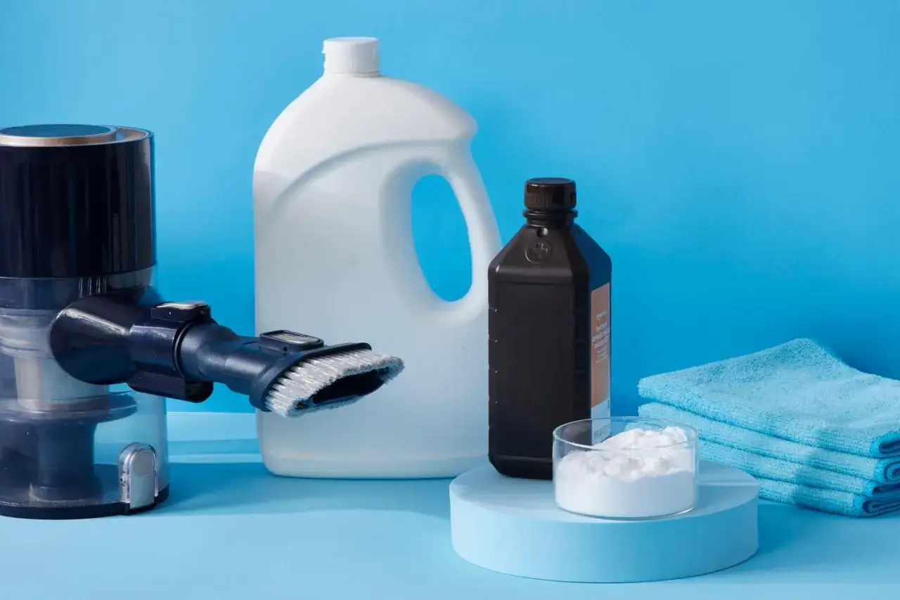 Vacuum cleaner attachment, large jug, hydrogen peroxide, baking soda, and cloths. These items are what to clean mattress with for a fresh start.