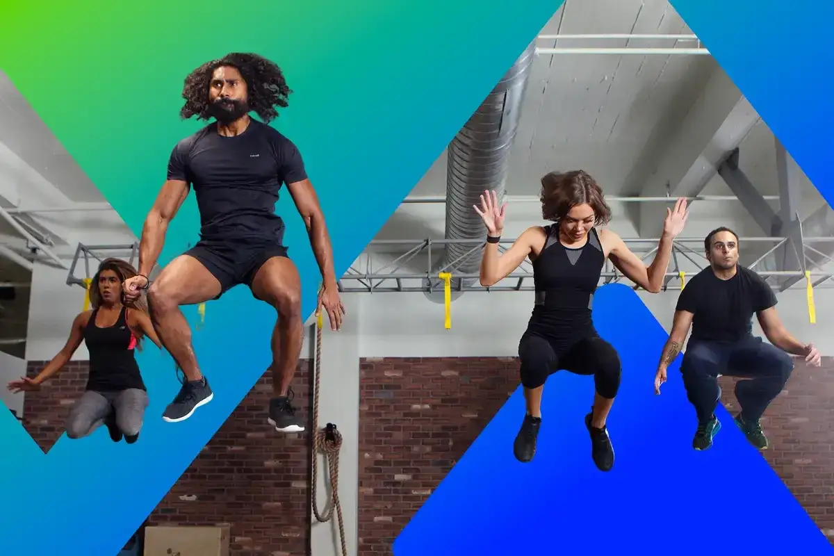 Four people jump in a gym, showcasing the physical **endurance** needed for intense workouts.