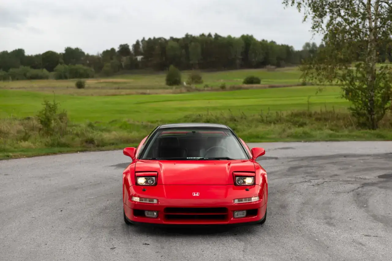 Röd Honda NSX till salu, redo för äventyr på landsbygden. En ikonisk sportbil som väntar på sin nya ägare.