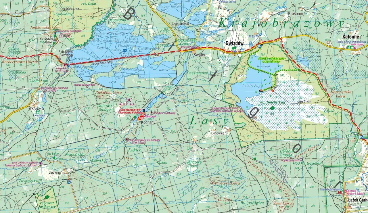 Mapa turystyczna przedstawiająca **lasy janowskie** z zaznaczonymi szlakami, rezerwatami i miejscami pamięci.