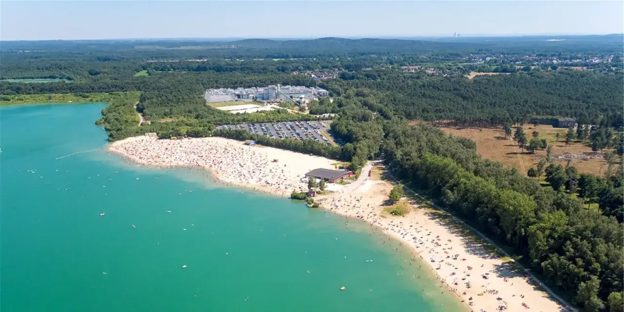 Sonniger Tag am **Silbersee Haltern am See**. Tausende Menschen genie&szlig;en das t&uuml;rkisfarbene Wasser und den Sandstrand.