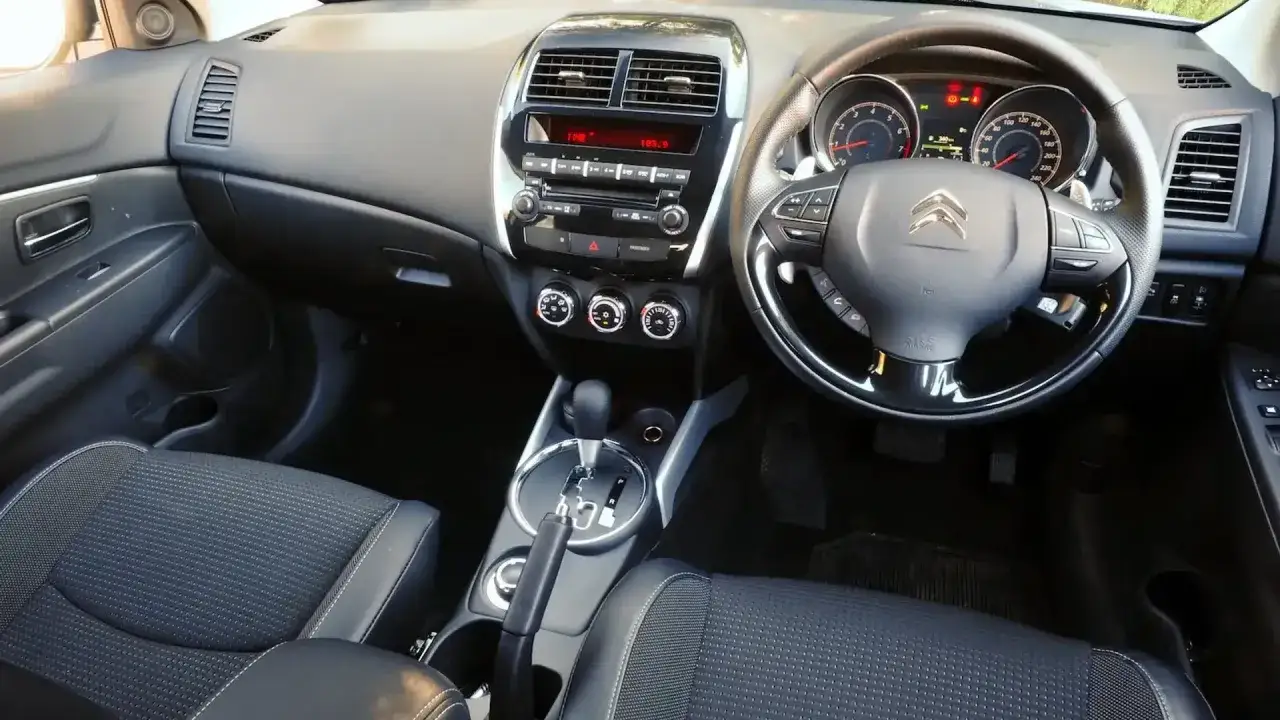 Wnętrze Citroen C4 Aircross z kierownicą, deską rozdzielczą i fotelami.