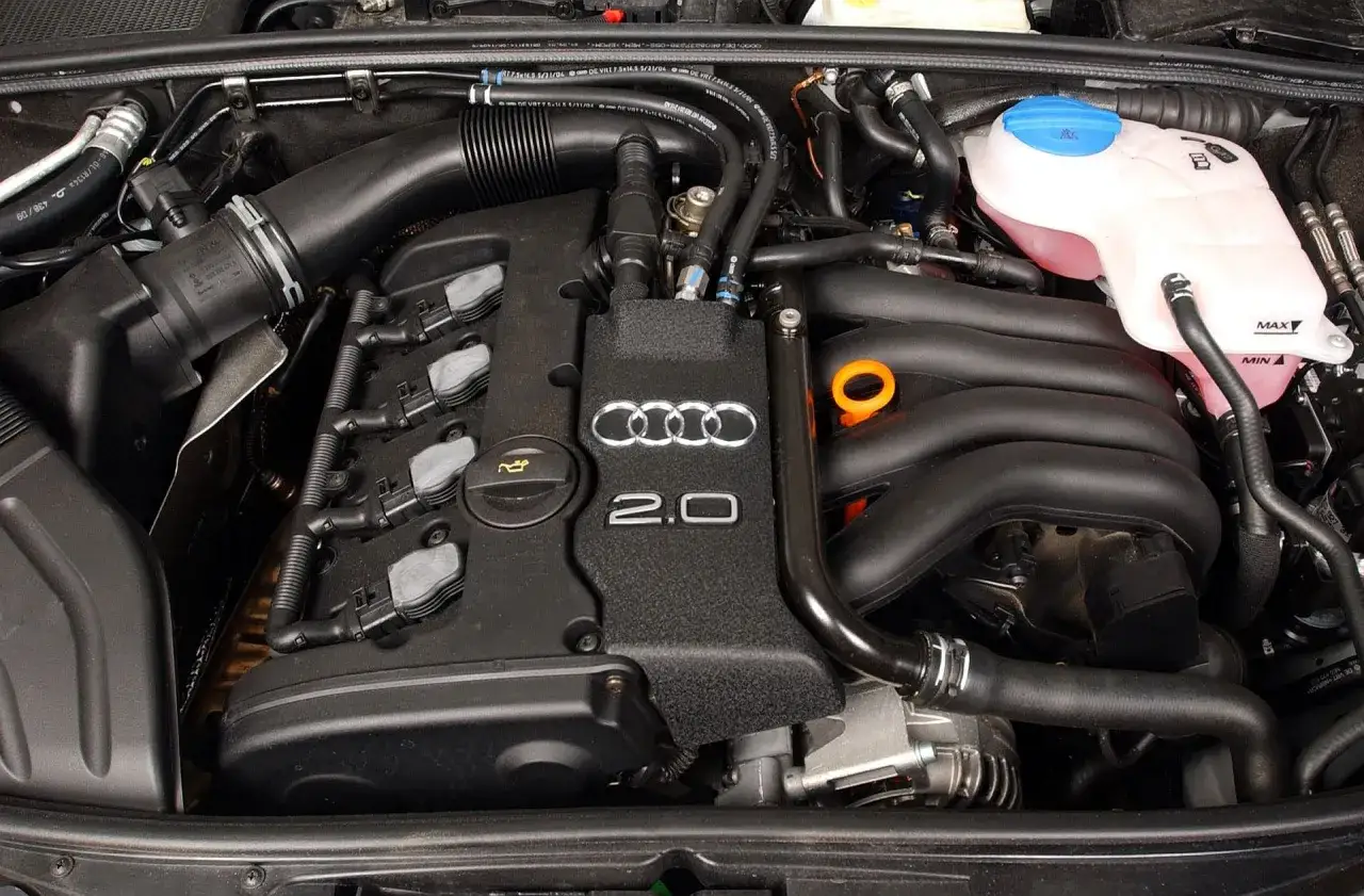 Silnik 2.0 TFSI z Audi B7, z widocznymi cewkami zapłonowymi, kolektorem dolotowym i zbiorniczkiem płynu chłodniczego.