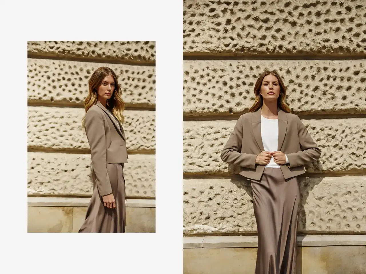 Elegancka, beżowa marynarka damska w połączeniu z satynową spódnicą tworzy stylowy zestaw. Modelka prezentuje ją na tle kamiennej ściany.
