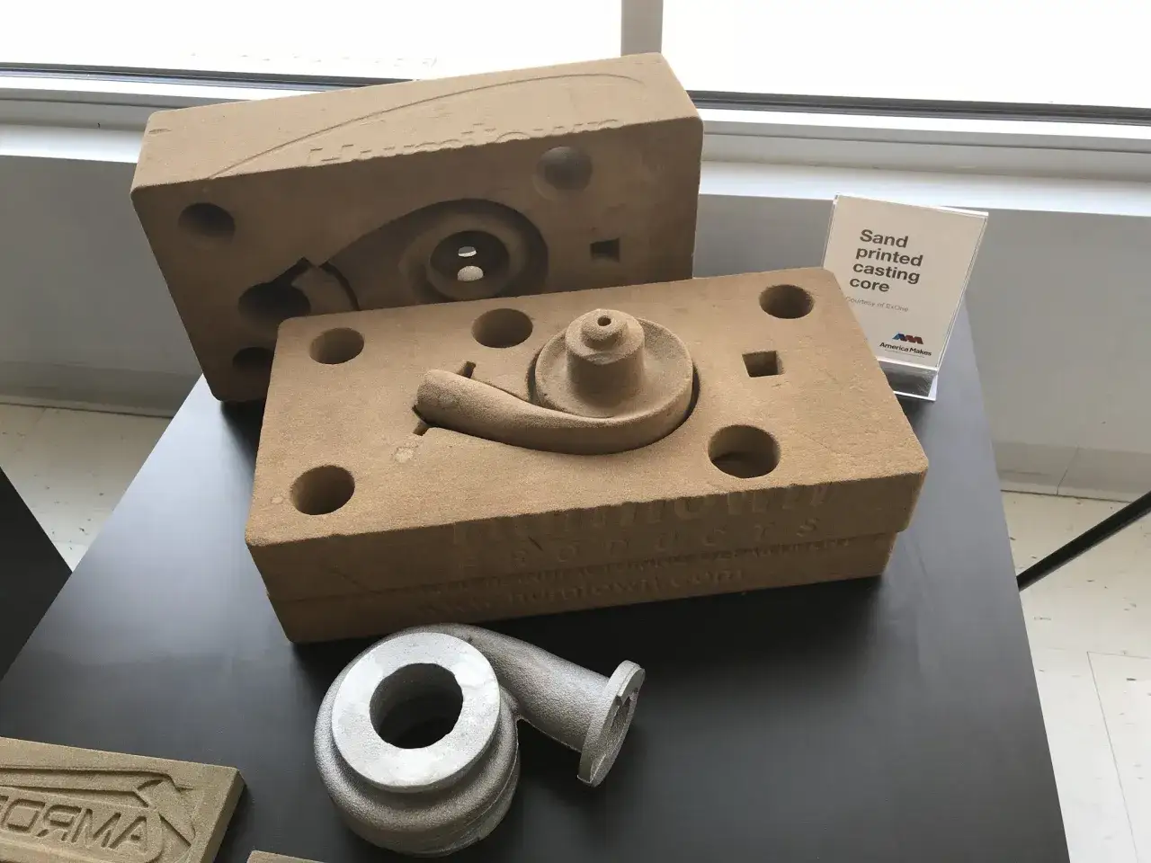 Sand printed casting cores and a metal turbine impeller, showcasing advanced 3d printing for casting applications.