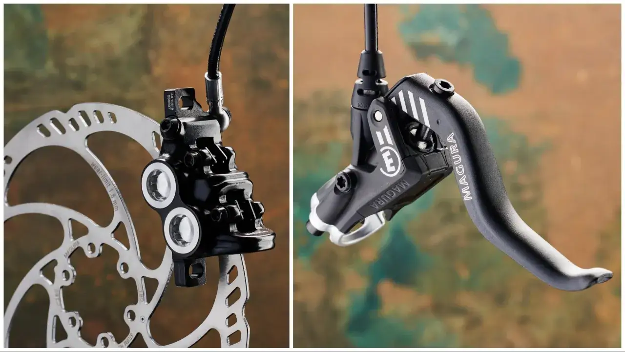 Close-up of a bicycle disc brake rotor and caliper on the left, and a Magura hydraulic brake lever on the right.