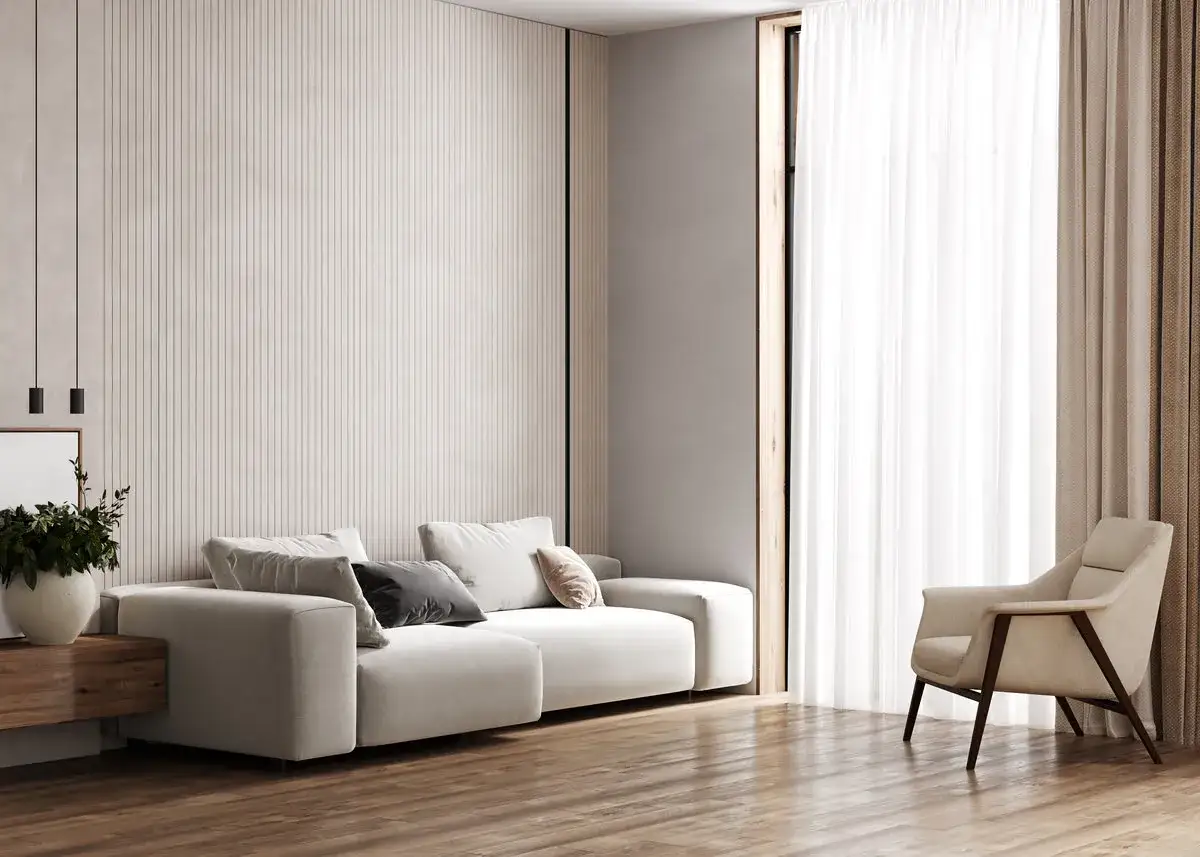 Sofá blanco roto y sillón beige, con cortinas blancas y detalles en madera. La pared tiene un diseño de líneas verticales.